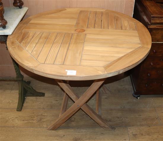 A circular teak folding garden table Diam.90cm